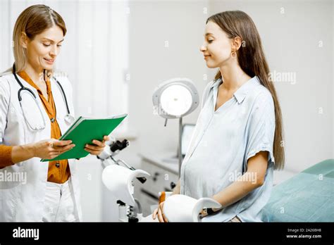 Young Pregnant Woman Sitting On The Gynecological Chair During A Medical Consultation With