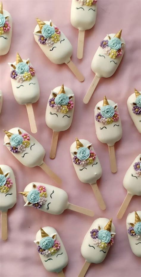 Unicorn Lollipops With Blue Flowers And Gold Horn On Them Sitting On A