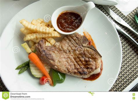 Steak With Pepper Sauce On A Plate Together With Vegetable Stock Photo