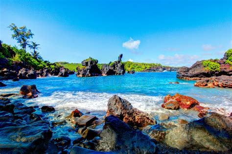 Waves Breaking On The Rocks On A Sunny Day Maui Hawaii Stock Photo