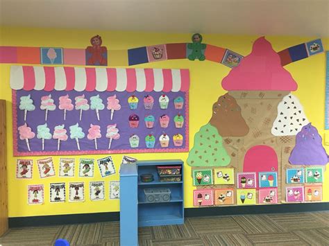 Candyland Theme Bulletin Board With Cotton Candy And Cupcakes Above