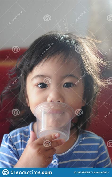 An Asian Girl Plays A Plastic Cup Stock Image Image Of Plays Girl