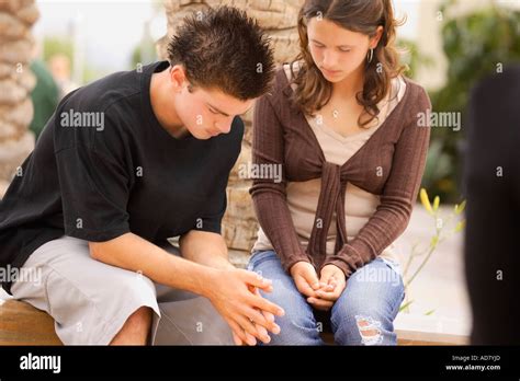 Two Teens Praying Together Stock Photo Alamy