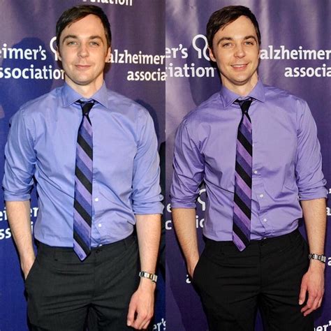 Two Men In Purple Shirts And Black Ties Posing For The Camera With
