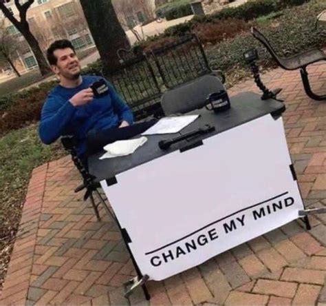 Change My Mind Guy Sitting On A Chair Outside In Front Of A Table
