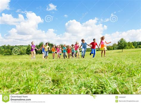 Large Group Of Kids Running In The Park Royalty Free Stock Photography