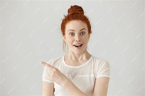 Free Photo Excited Young Redhead Caucasian Woman With Hair Knot