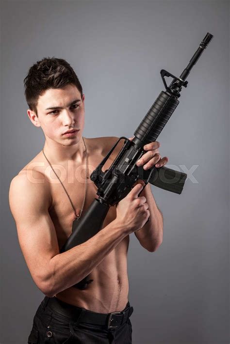 Handsome Bare Chested Soldier Is Holding A Rifle Stock Image Colourbox