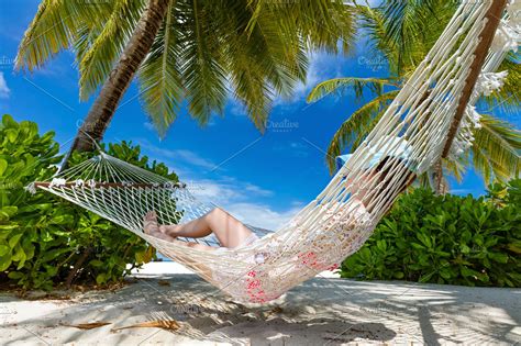 Woman Lying On Hammock Between Palms On A Tropical Beach Maldives