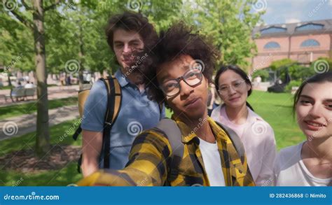 Cheerful Smiling Multiracial Friends At Park Taking Selfies Stock