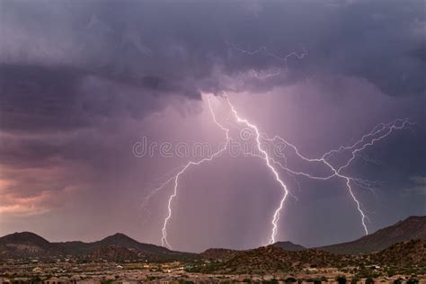 Thunderstorm Lightning Bolt Striking A Mountain Range Stock Photo