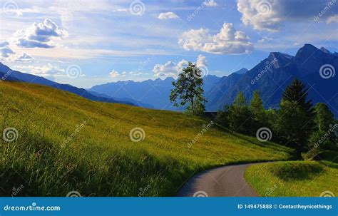 Swiss Alps Beautiful Mountains With Green Meadow With Blue Sky And