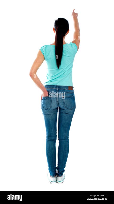 Rear View Of Young Woman In Casuals Pointing At Copyspace Stock Photo