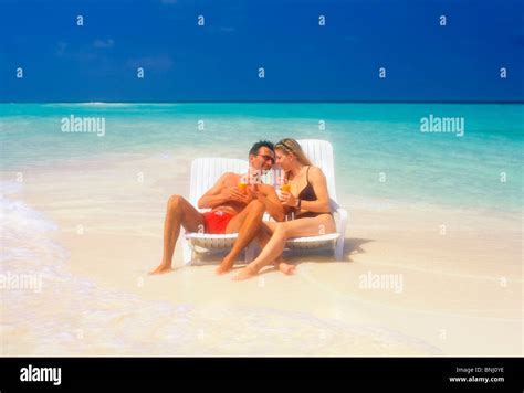 Pair Couple Vacation Holidays Travel Maldives Beach Seashore Deck Chair Bikini Drink Sea