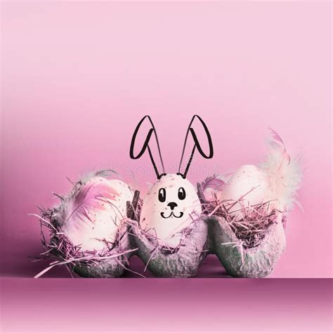 Easter Bunny Rabbit Painted On Eggs At Pastel Pink Background Stock