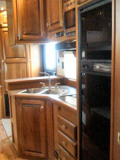 An outdoor kitchen does not replace the indoor kitchen in the rv, but gives an additional option for rvers who enjoy cooking outdoors. huge kitchen for a trailer | Huge kitchen, Custom trailers