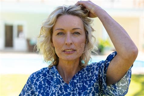 Portrait Of Caucasian Senior Woman Touching Her Hair While Standing In