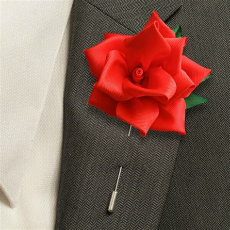Red Flower Lapel Pin On A Suit