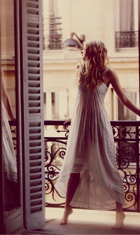 A Woman Standing On A Balcony At Dawn Her Hair Down Her Loose