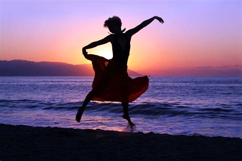 640294 Dramatic Image Of A Woman Dancing By The Ocean At Sunset The Sentinel