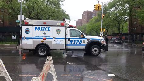 A Police Truck Driving Down The Street In The Rain