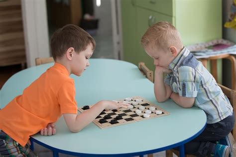 Premium Photo Preschool Boys Play Chess