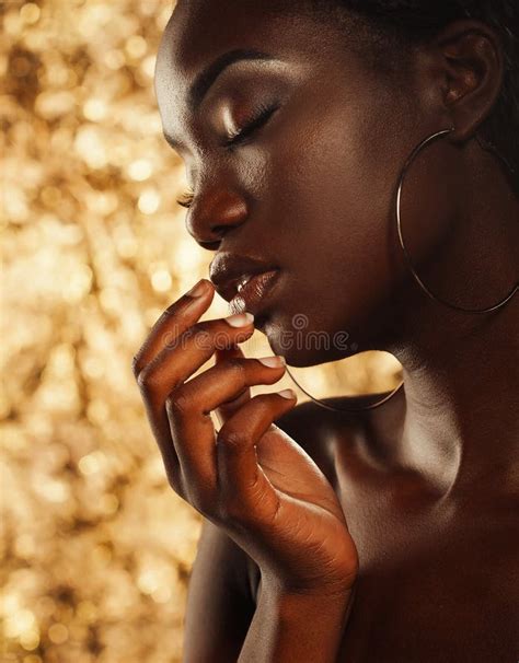 Portrait Of Sensual Young African Woman Against Golden Background Stock