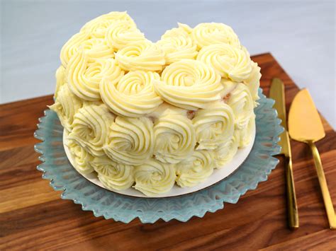 The vibrant designs on this cake were created using edible icing sheets, a very effective and easy decorative technique. How To Decorate A Layer Cake With Vanilla Buttercream Rosettes