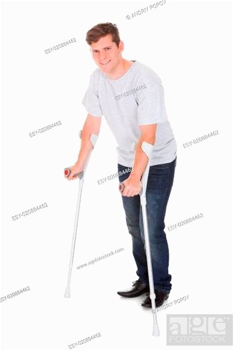 Young Man Walking With Two Crutches Stock Photo Picture And Low