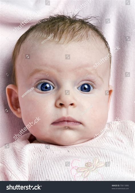 Cute Newborn Baby Girl With Big Blue Eyes On Pink