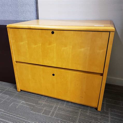 Features putty/beige finish with metal construction. Used Two Drawer Lateral File Cabinet - Vision Office Interiors