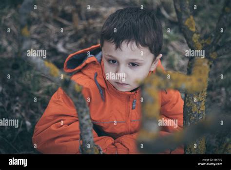 Portrait Of Sad Little Boy Outdoors At The Day Time Concept Of Dreary