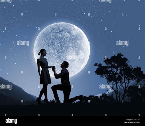 Silhouettes Of Romantic Couple Under The Moon Light Stock Photo Alamy