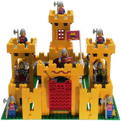 A Lego Castle Made Out Of Yellow And Red Bricks With Knights Standing