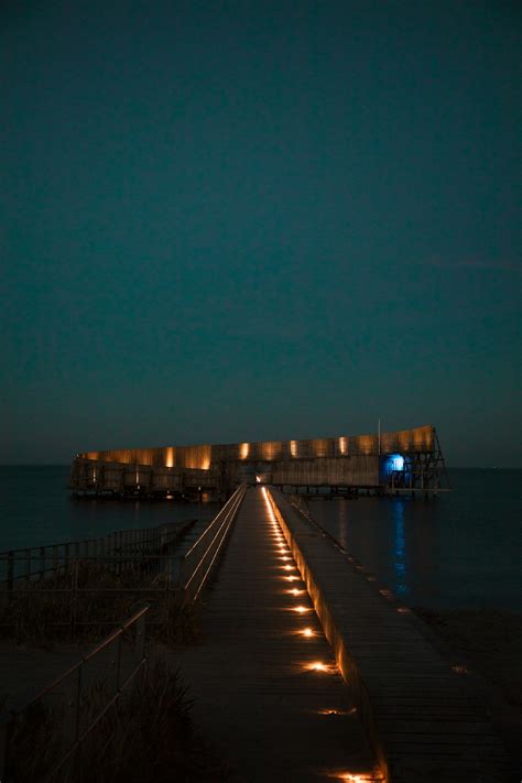 Brown Wooden Dock On Sea During Night Time Photo Free Water Image On