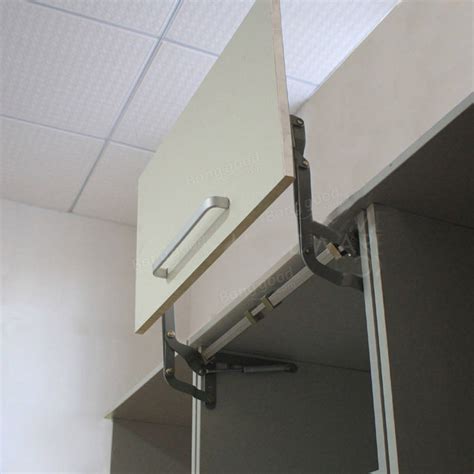 Now available for use in conjunction with or without the new automatic opening mechanism on a variety of door styles and multiple size wall cabinets. Original Arm Mechanism Hinges Vertical Swing Lift Up Stay ...