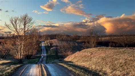 Road Between Dry Grass Field With Blue Sky And Clouds Background 4k Hd