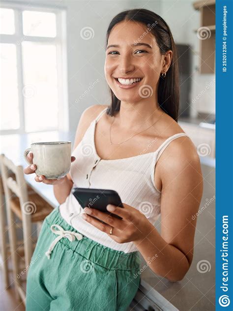 coffee and a good wi fi connection is all you need a woman holding her cellphone while drinking