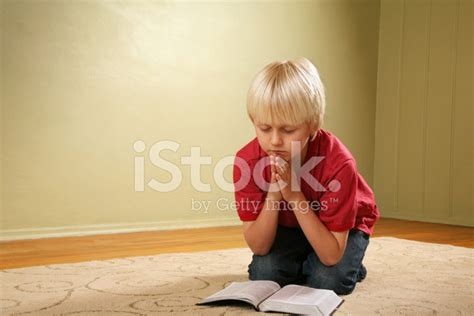Child Kneeling And Praying Stock Photo Royalty Free Freeimages