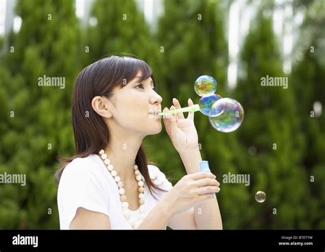 A Woman Blowing Bubbles Stock Photo Alamy