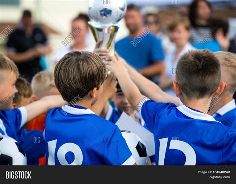 Young Soccer Players Holding Trophy Children Soccer Football Champions