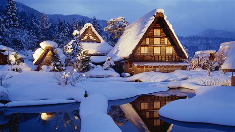 Christmas comes with merriment, joys and ecstasy. Houses Covered with Thick Snow, Lights Are Turned on, Warm ...