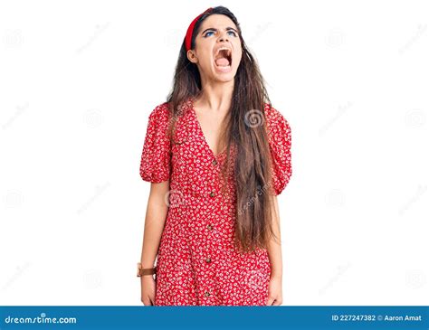 Brunette Teenager Girl Wearing Summer Dress Angry And Mad Screaming Frustrated And Furious