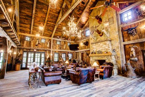 The downstairs of our deer hunting lodge offers 1,920 square feet entry, a beautiful log living room with stone fireplace. lodge-fireplace - OX Ranch