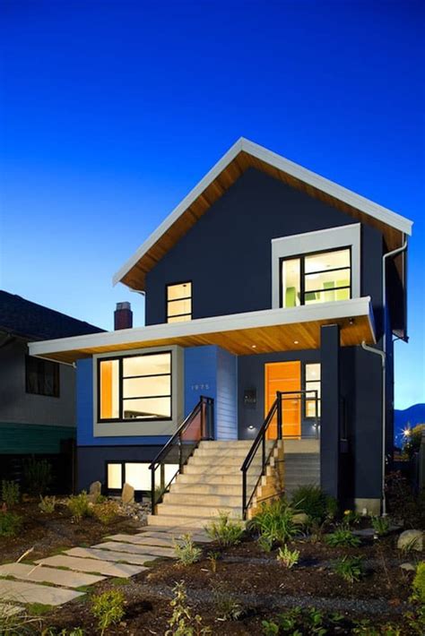 Light grey house with white trim. Modern Green Renovation in Vancouver by Marken Projects