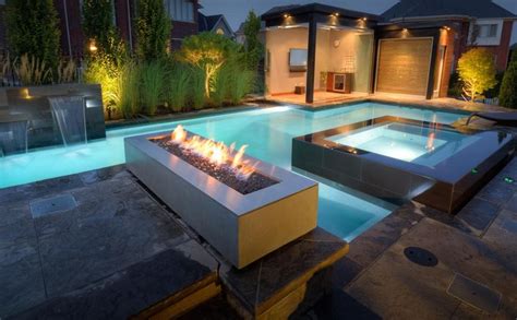Contemporary Swimming Pool With Fire Pit And Exterior Stone Floors