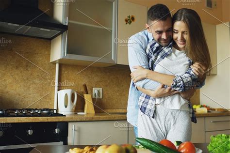 Happy Young Couple In The Kitchen Attractive Dancing Man Cooking While