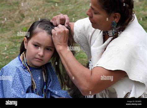 Native American Indian Lakota Sioux Woman Braiding The Hair Of A Young