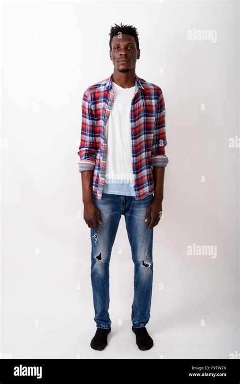 Full Body Shot Of Young Black African Man Standing Against White Stock