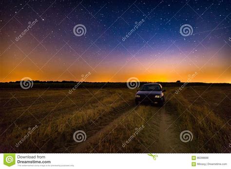 Rural Sandy Road Through Green Field And Blue Sky On Background Stock